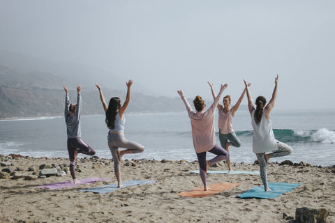 Woman doing yoga on the beach