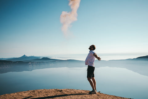Man standing outside in nature breathing in fresh air