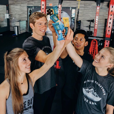 Group holding up Rise Bars in the gyms