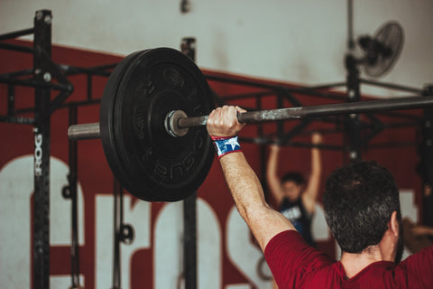 Man lifting weight over head