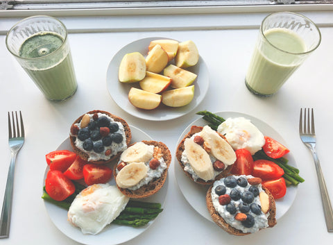 Plates of fruit, toast, eggs, and juice