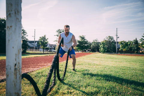 Man working out with ropes outside