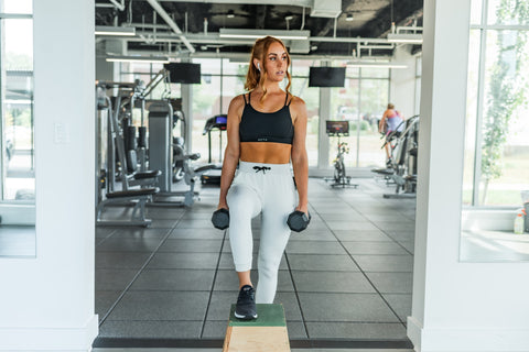 Woman in the gym holding weights