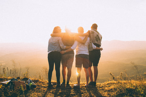 Friends on a hike watching the sunset together