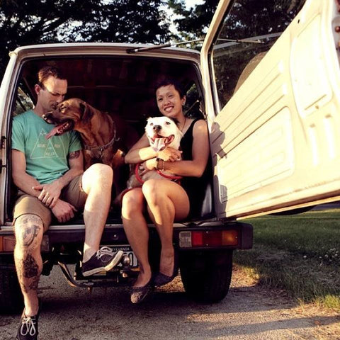 Family in trunk of car with two dogs