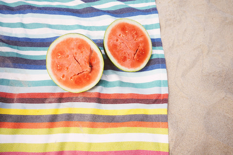 Watermelon on beach towel on beach